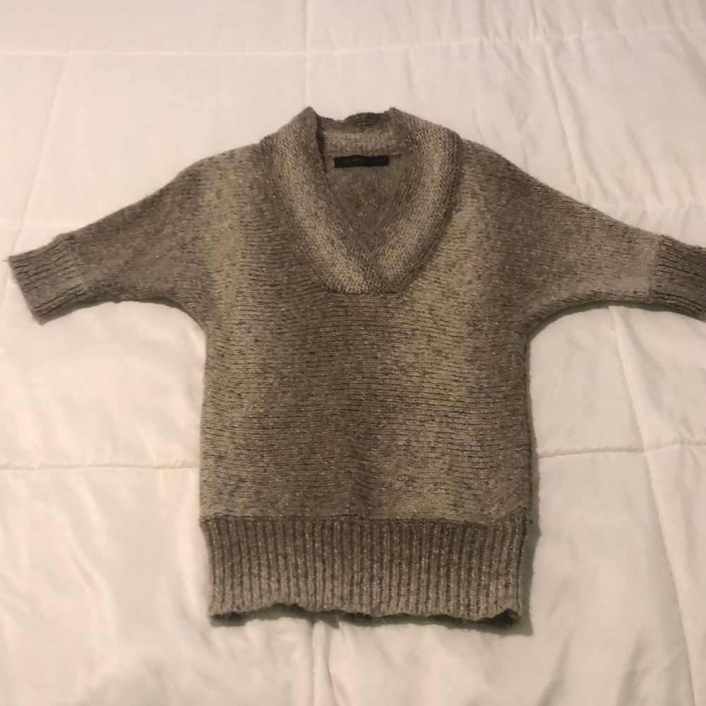 Express warm tan and cream sweater to the sleeve